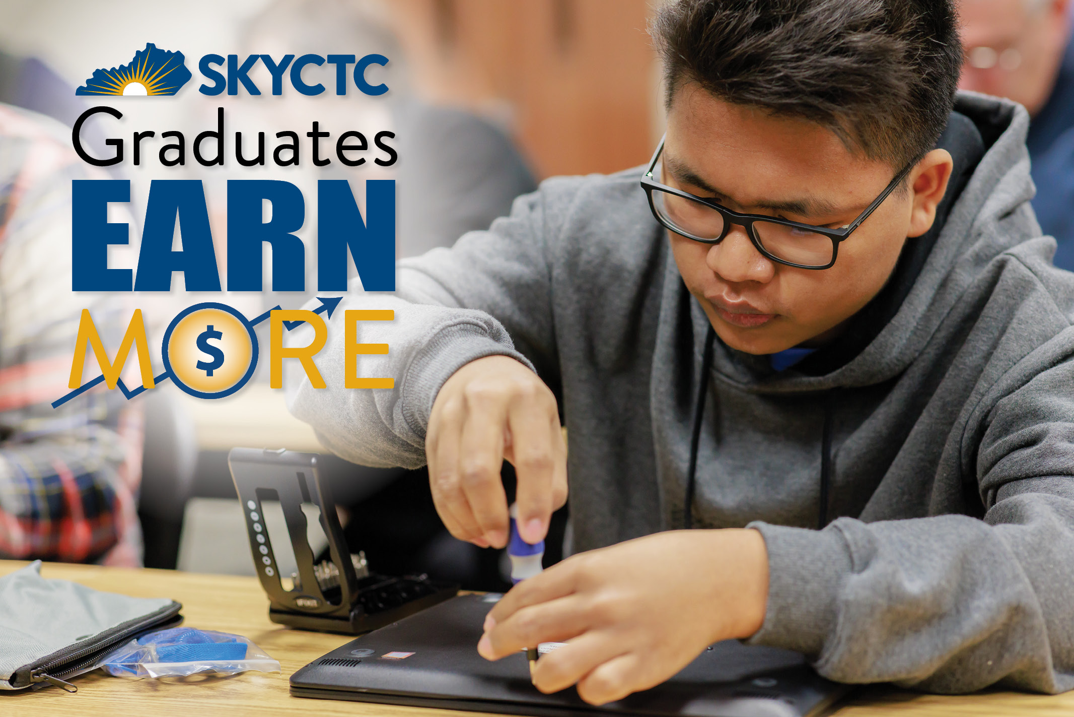 A guy working on computer motherboard. SKYCTC Graduates Earn More.
