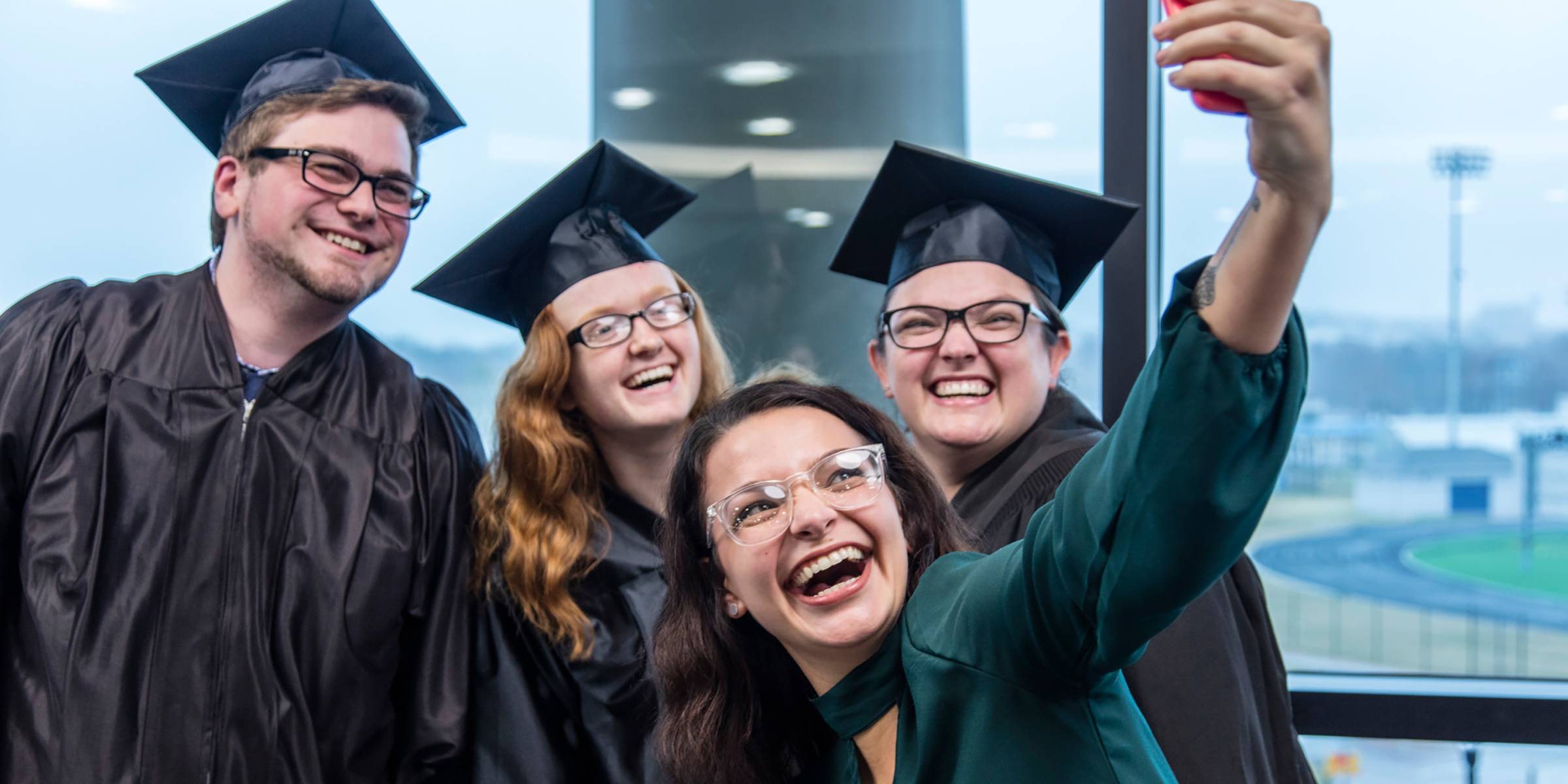 Four graduates taking a selfie