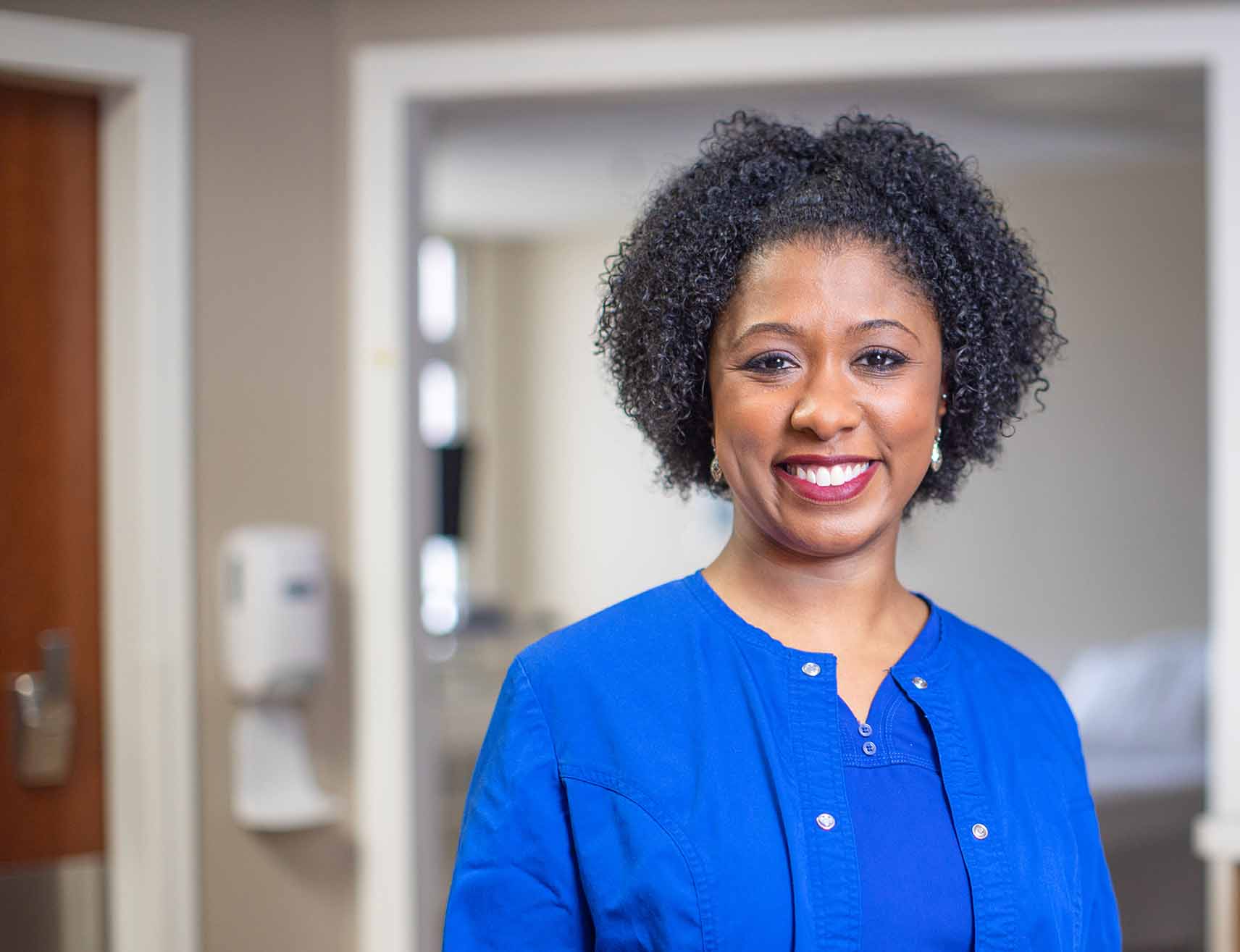 African American woman dressed as nurse looking at the camera smiling