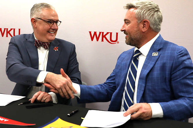 WKU President Timothy C. Caboni (left) and KCTCS President Ryan Quarles, extend congratulation at the transfer signing agreement event. 