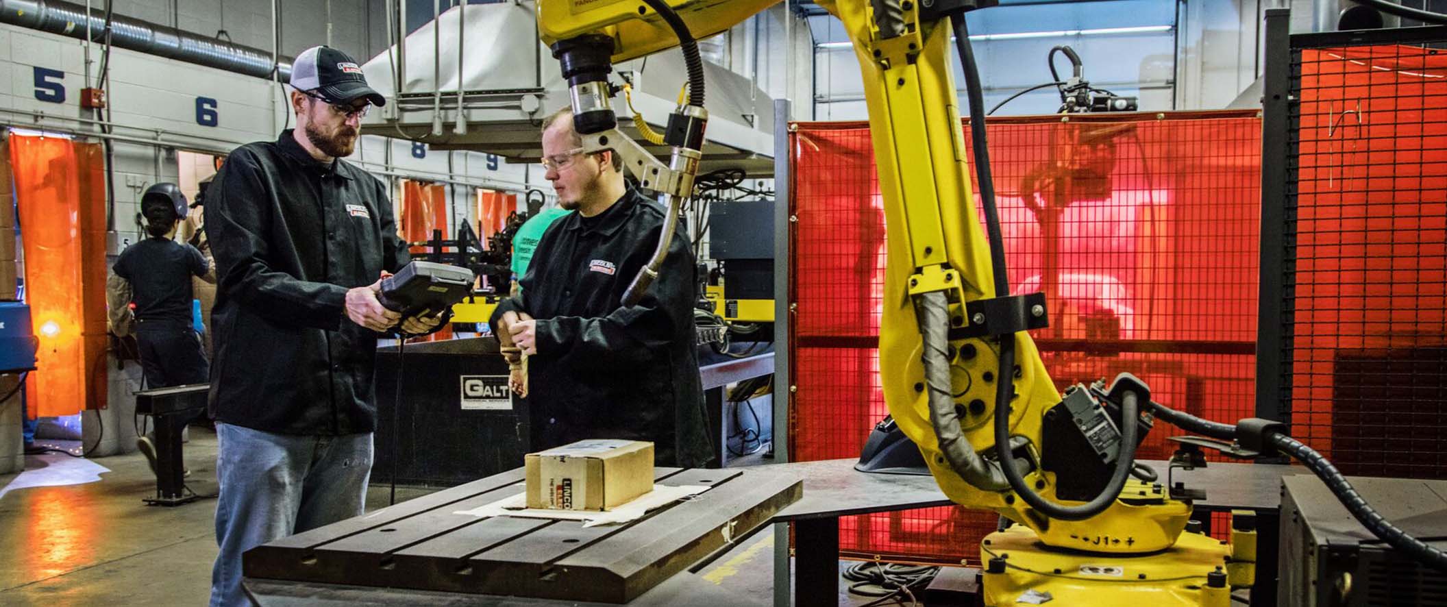 two men working in manufacturing in class work area setting