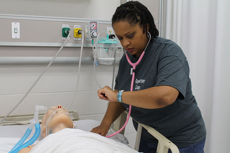 Respiratory Care student practicing skills on a manikin.