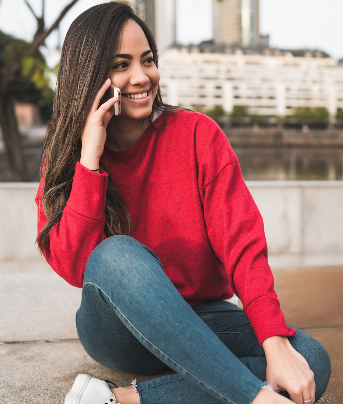 Individual sitting, talking on phone