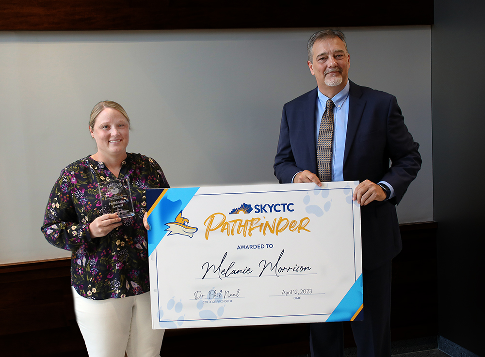 Melanie Morison hold awrd sign with SKYCTC President Dr. Phil Neal