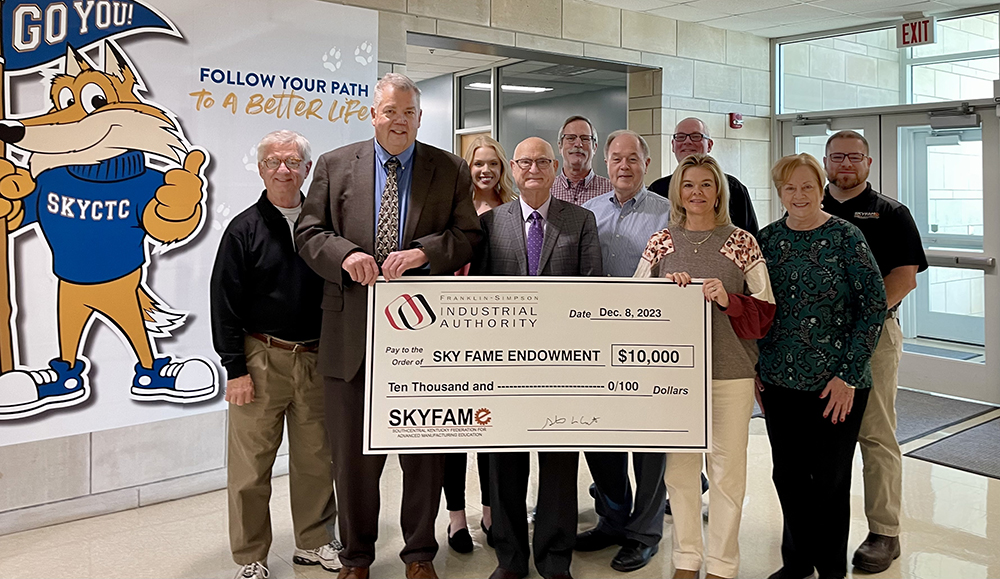 Members of the Franklin-Simpson Industrial Authority present a large size check to members of SKYCTC