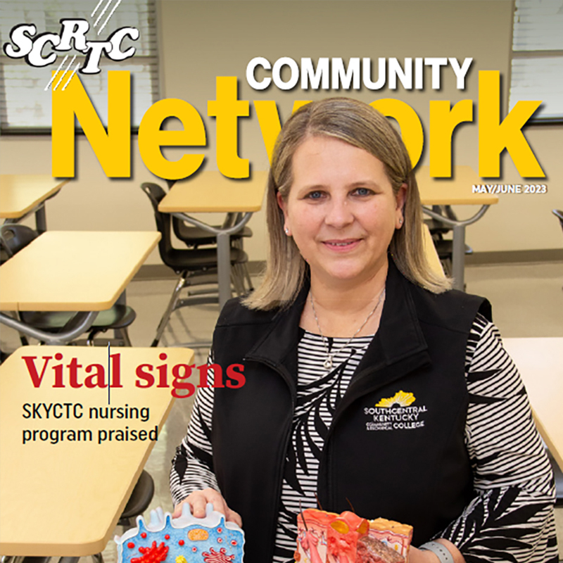 Dr. Angie Harlan standing in classroom holding health care models. Words on photo are SCRTC Community Network, vital signs, SKYCTC nursing program praised.