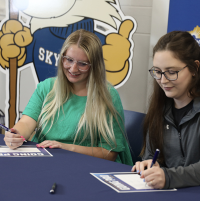 Two female SKYCTC Allied Health students signing the Going Pro certificate