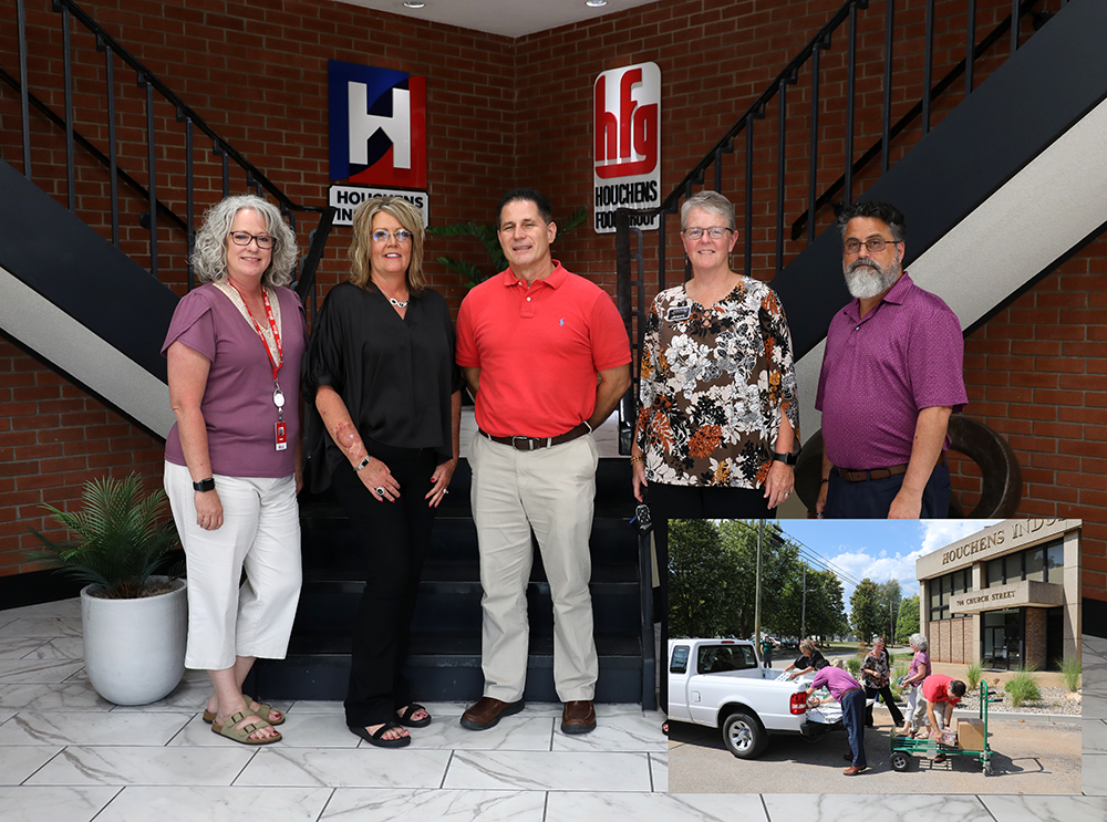 Five people standing for photo with picture of people loading a truck in lower part of photo