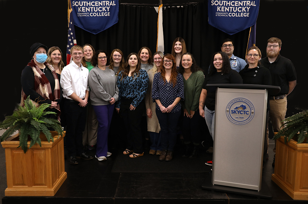 All eleven Medical Lab Technology graduates standing on stage