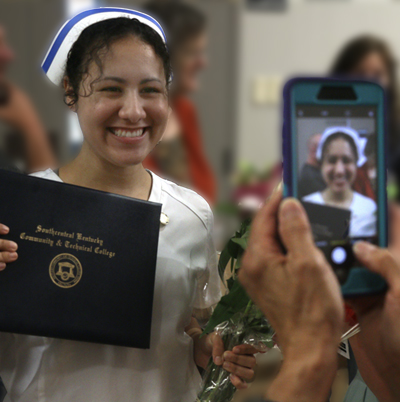 Nursing student having her picture taken with a cell phone