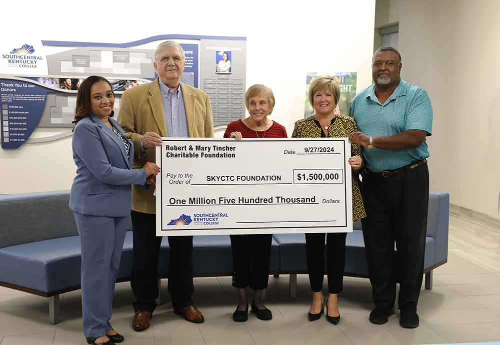 Six people holding oversized check