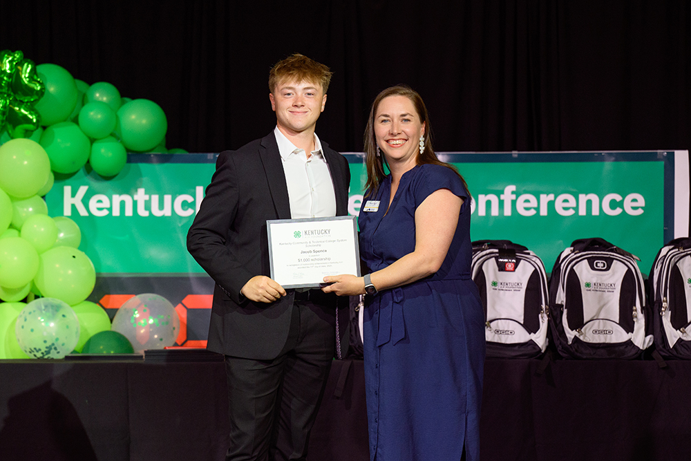 • Jacob Spence irecieves the scholarhsip from female sponsor