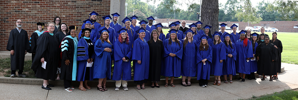 Entire group of GED graduates and faculty and staff standing for a photo
