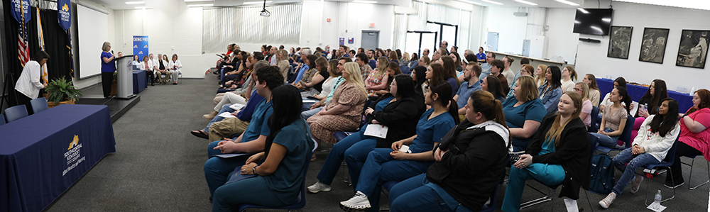 room full of allied health student listening to speaker