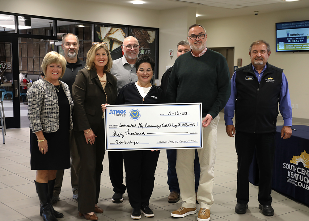 People standing with oversized check presentation