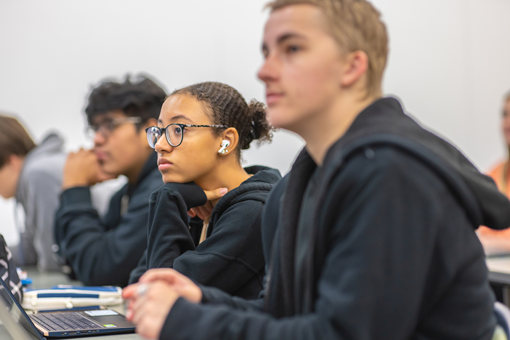 Student setting at a desk looking at instructor