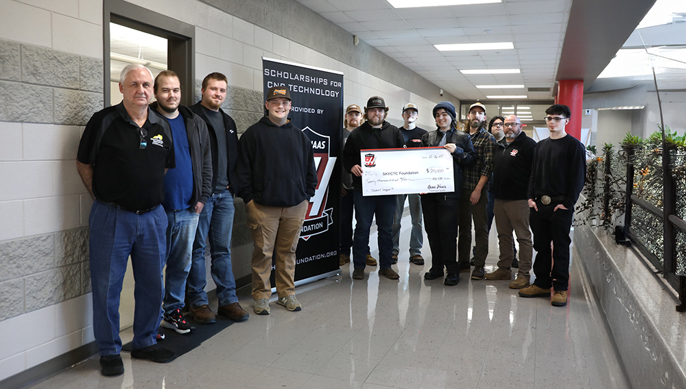 Students and instructors of the SKYCTC Machine Tool program holding an oversized check from the Gene Haas Foundation