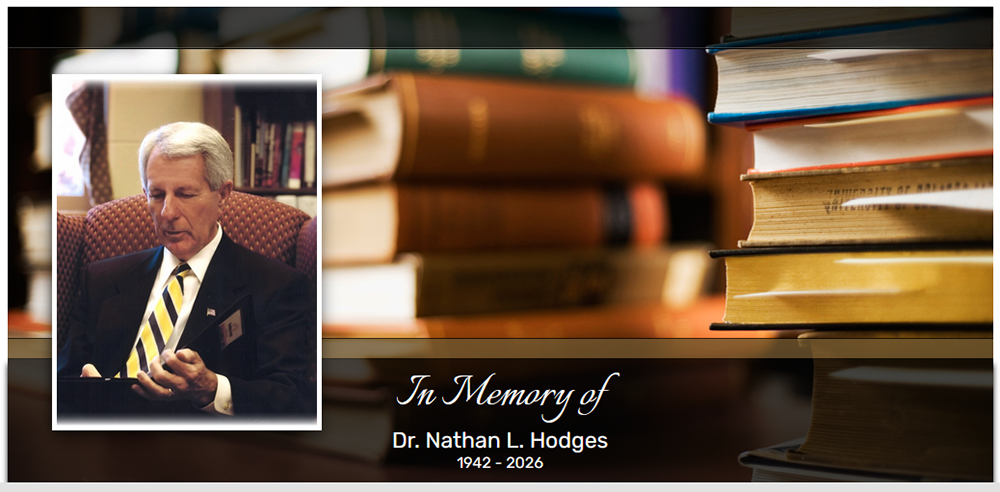 Image of Dr. Nathan Hodges reading a book with text: Dr. Nathan L/ Hodges, 1942-2026