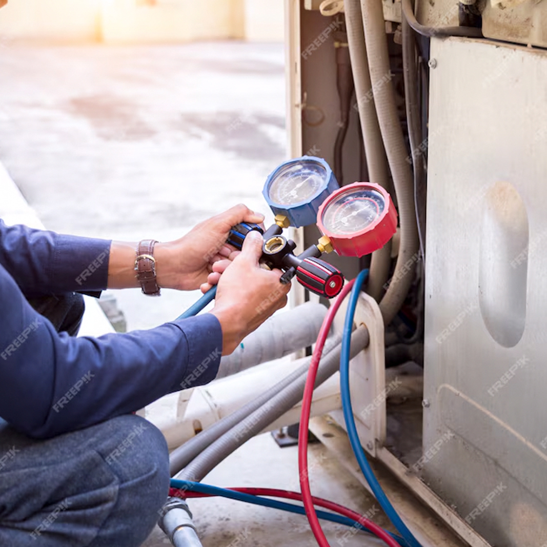 close up photo of hands holding HVAC gauge.