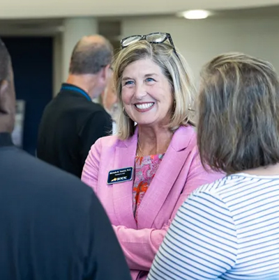 Michelle Trawick talking with community partners at her reception
