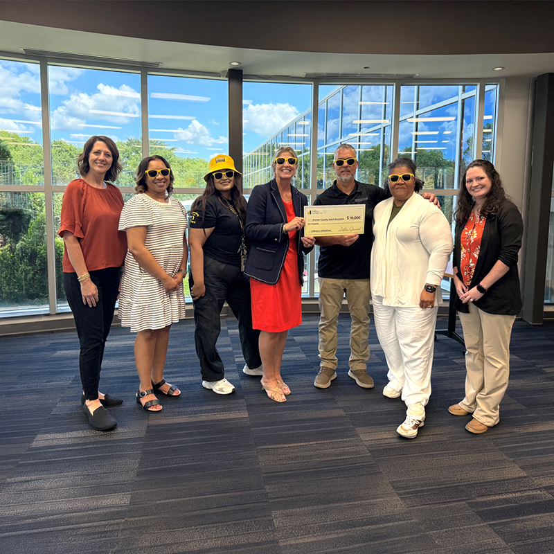 Dollar General Human Resources Manager Fabby Castellanos (left) and Plant Director Donald Cook (right) present a $10,000 donation to Warren County Adult Education Director Dr. Joda Johnson on Aug. 4, 2026. The Dollar General Distribution Center selected Warren County Adult Education as one of its community partners in recognition of the organization's impact on adult learners and the local community.