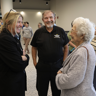 Gene Basil speaking with his mother and SKYCTC President Dr. Michelle Trawick at his retirement reception