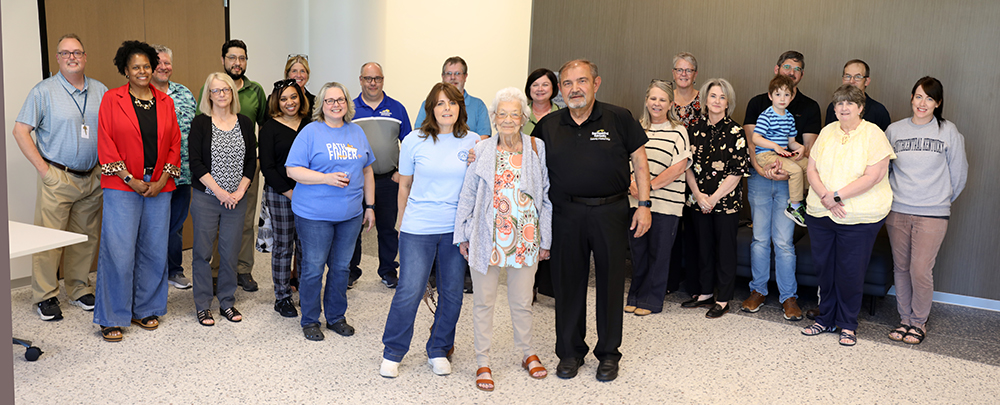 Large group of people standing with Dr. Gene Basil at his retirement celebration