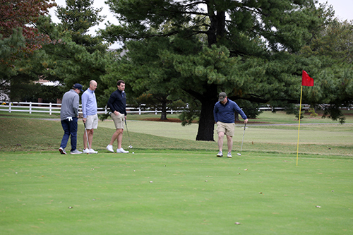Four men playing golf