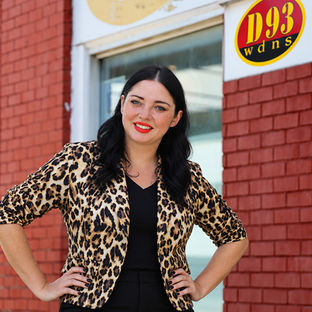 Jame Constant standing in front of the radio station