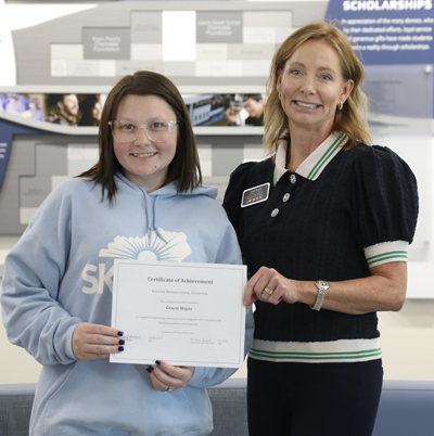 April Harris present scholarship to Gracie Hayes