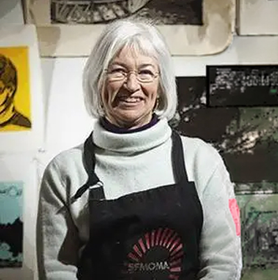 Laurin Notheisen standing in front of some of her art work