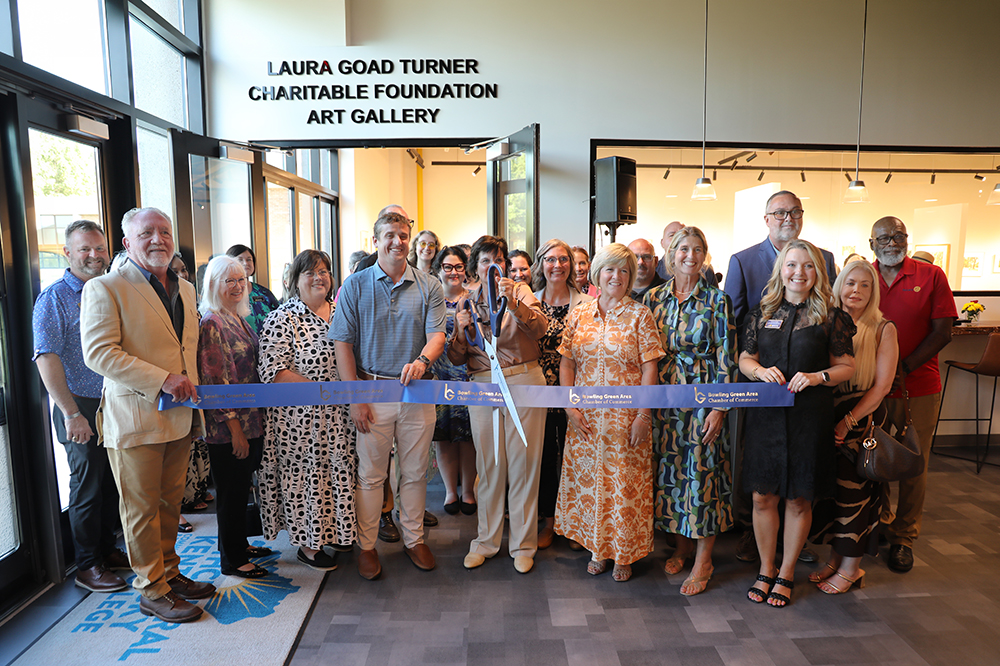A group of people cutting a grand opening ribbon in front of the Laura Goad Turner Charitable Foundation Art Gallery.