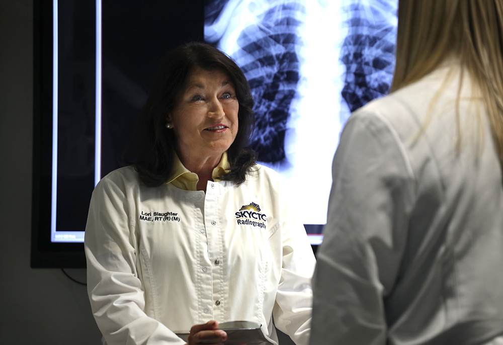 Lori Slaughter talking to a student in the Radiography Lab