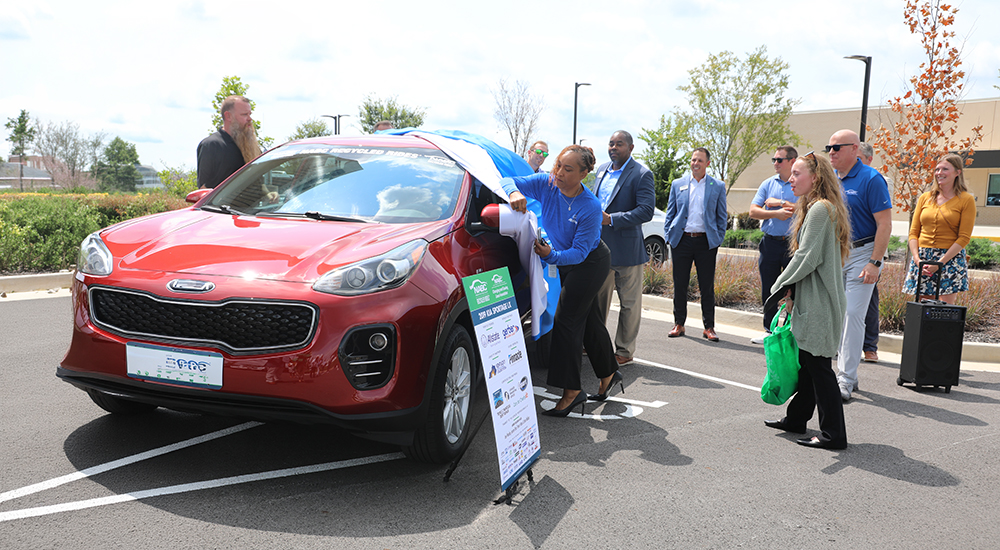 People unvailing new car donated to nrsing student
