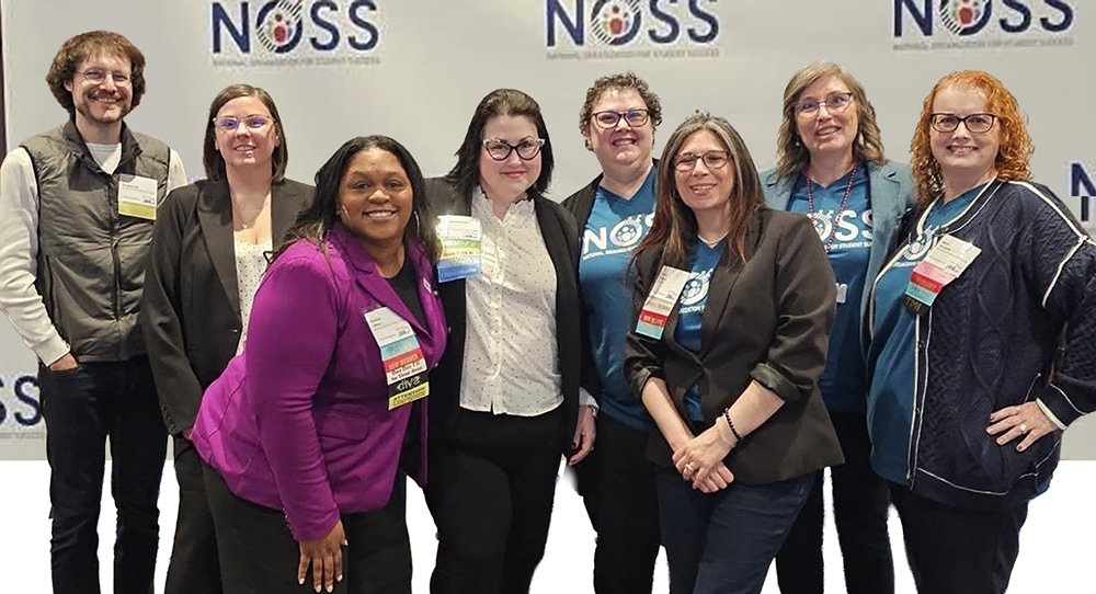 Group of people standing in front of NOSS background