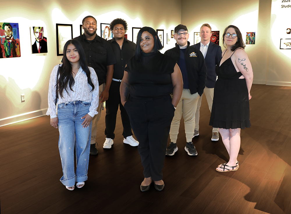 Seven SGA officers and members standing in an art studio
