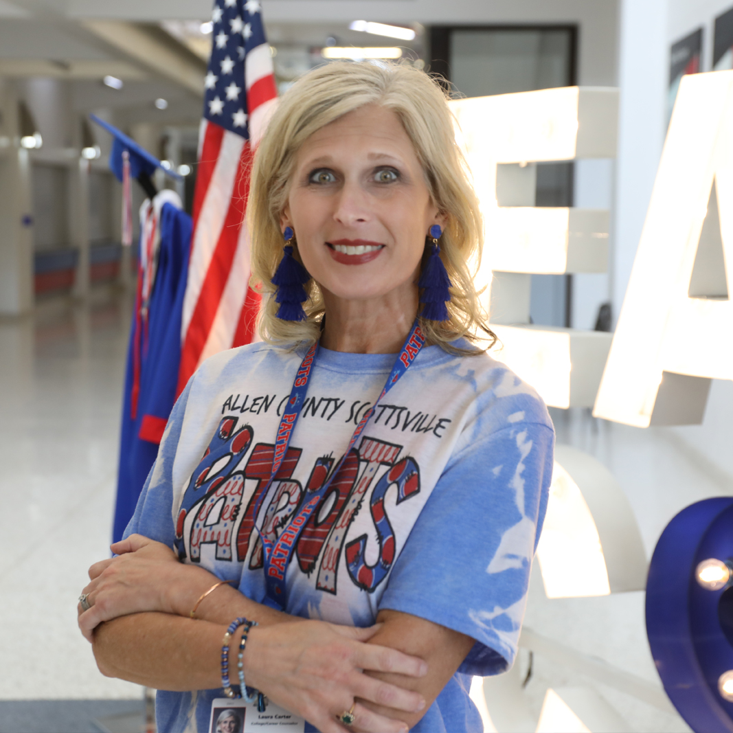 Laura Carter standing in front of Allen County High School sign
