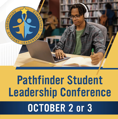 Male student at a desk on a laptop with words Pathfinder Student Leadership Conference October second or third