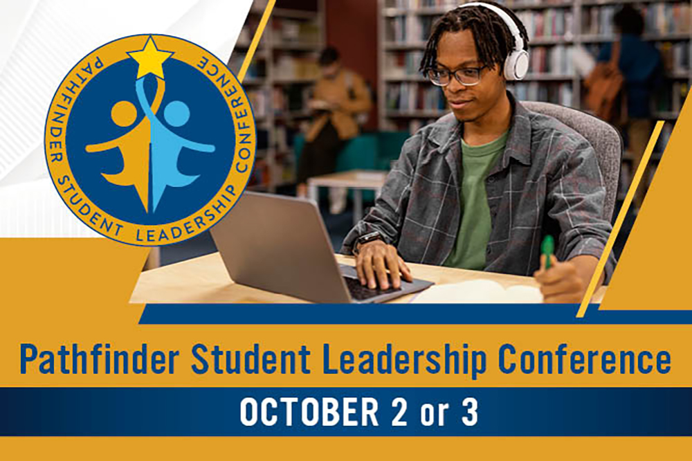 Male student working on a laptop with teh words Pathfinder Student Leadership Conference October 2 or 3