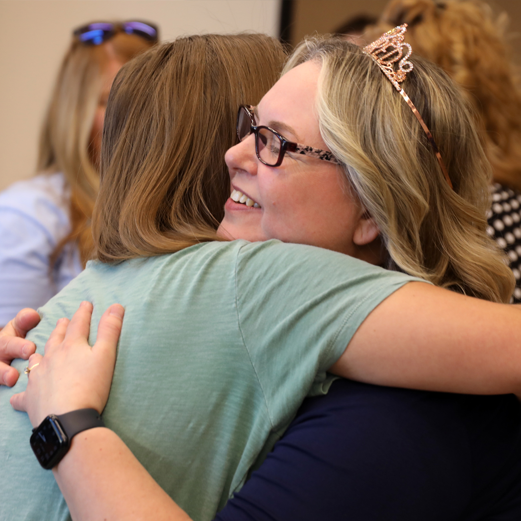 Carmen Gaskins hugging a person at her retirement reception.