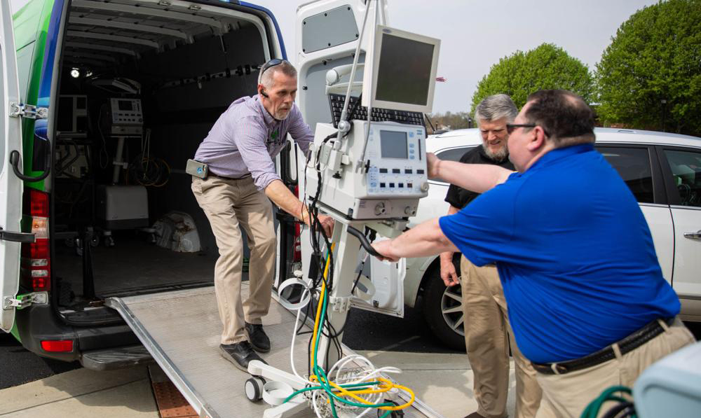 SKYCTC Respiratory Care Director of Clinical Education Ken McKenney (right) helps Randy East of the Medical Center Health Center of Bowling Green load the 13 ventilators the SKYCTC Respiratory Care Program loaned to the Medical Centers van on Friday, March 27, 2020.