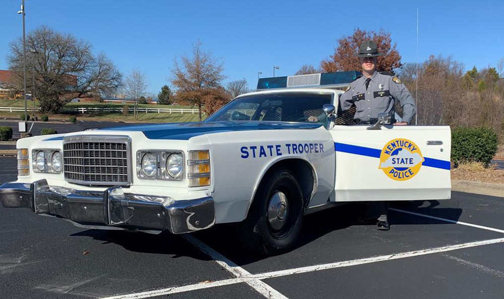 State Police Trooper stands by restored 1978 crusier . 