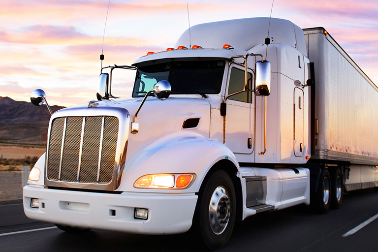 Semi-truck driving down a road