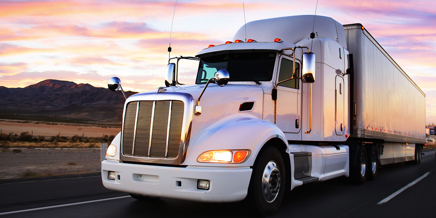 Semi-truck driving down the road