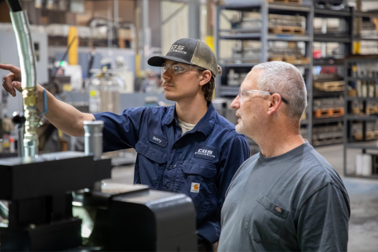 2 people in a factory setting